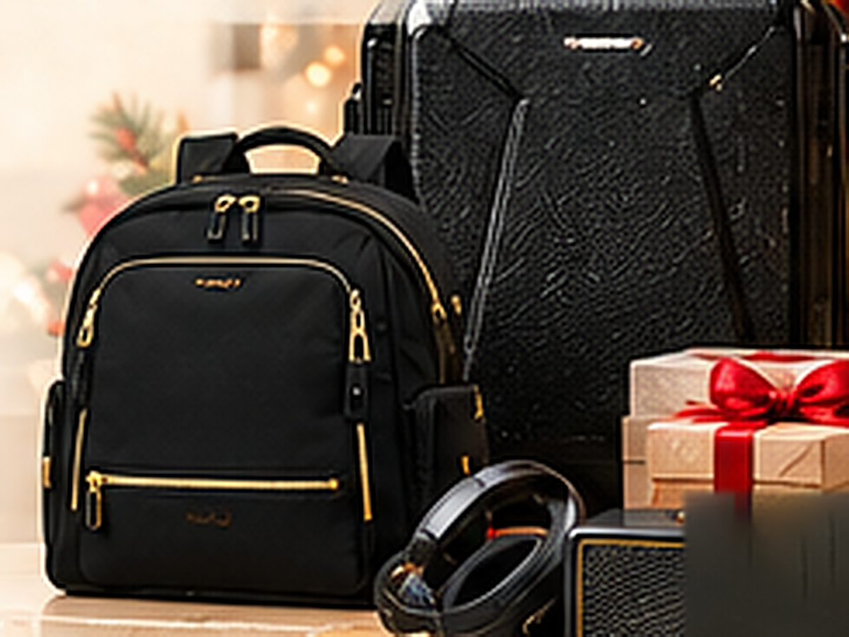 Black travel backpack, hard-shell luggage and a wrapped gift from the Executive and VIP collection.